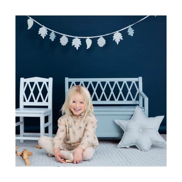 Child playing in room featuring leaves garland in mix blue