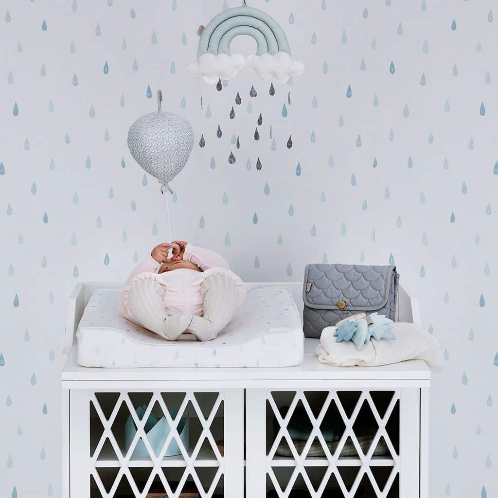 Nursery featuring changing cushion in raindrops pattern