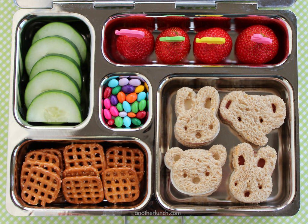 Kids lunchbox with sandwich pretzels cucumber and lollies