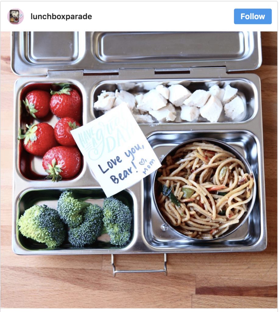 Homemade kids lunch in sustainable lunchbox with note from mom