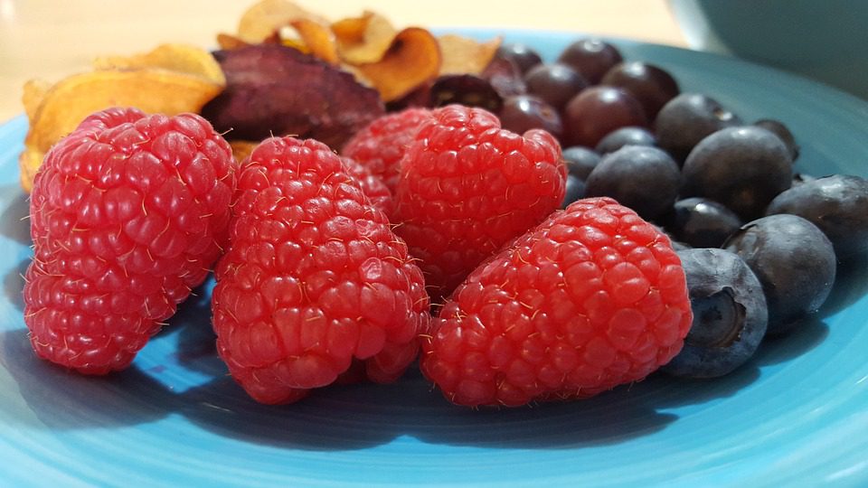 Kids healthy lunchbox with raspberries and blueberries