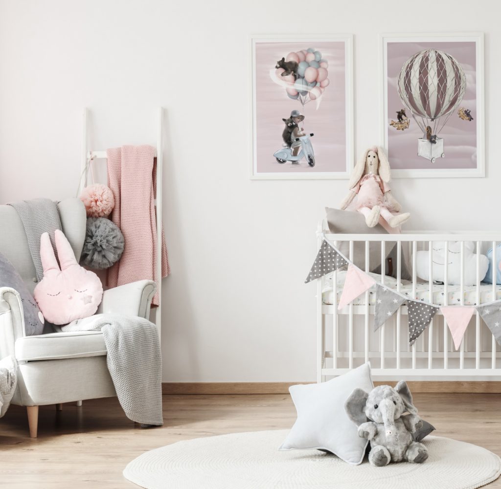 Light and pink coloured nursery with two Linn Wold wall prints on the wall