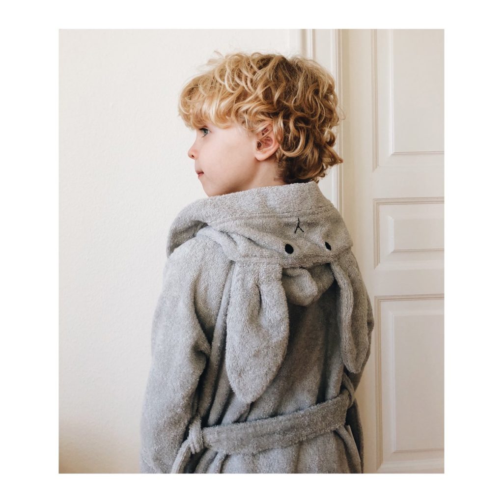 A boy with a rabbit ear bath robe